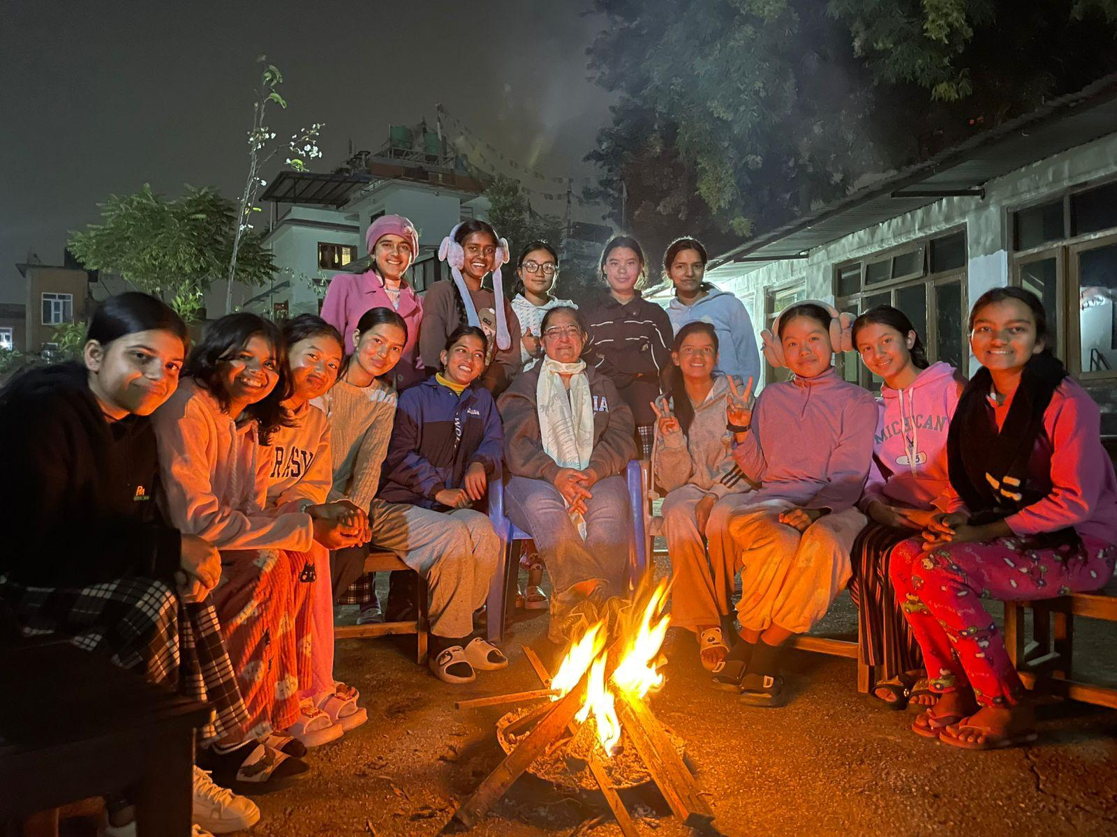 Girls gathered together around a fire